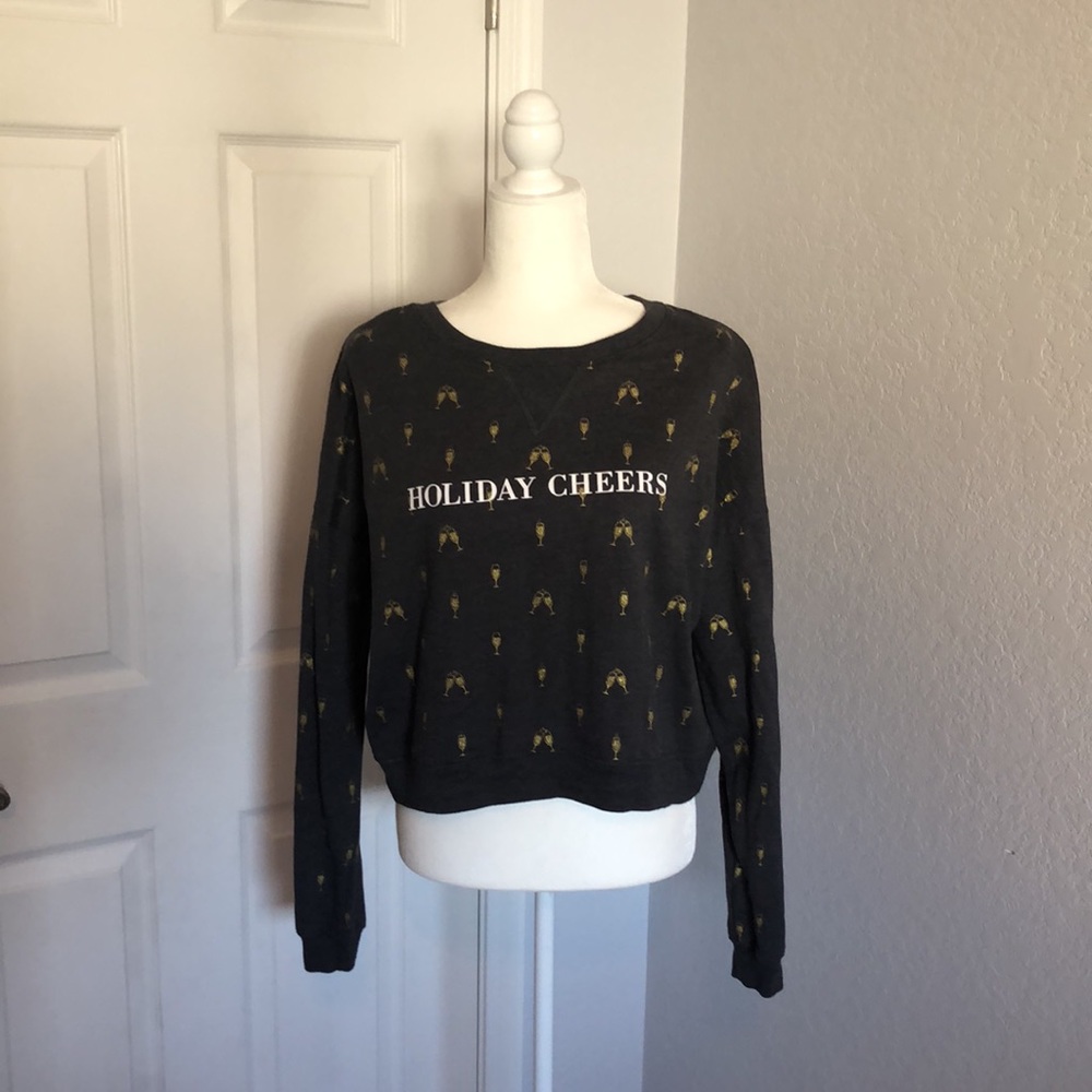 Holiday Cheers crop sweatshirt with sparkly champagne glass design.
